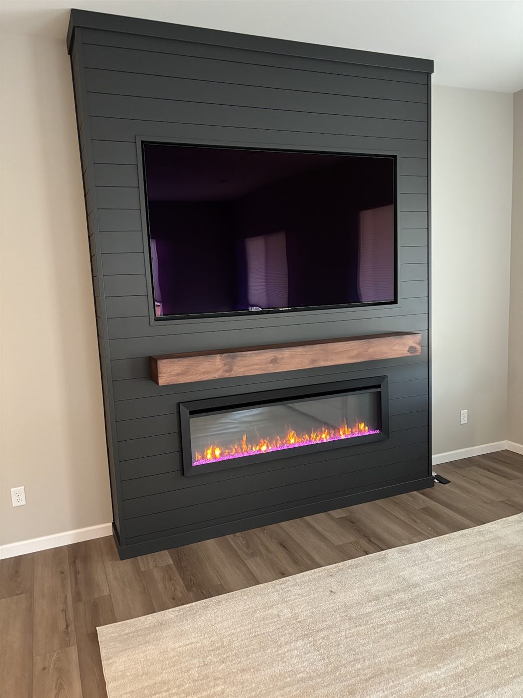 Shiplap media walls with wood mantel