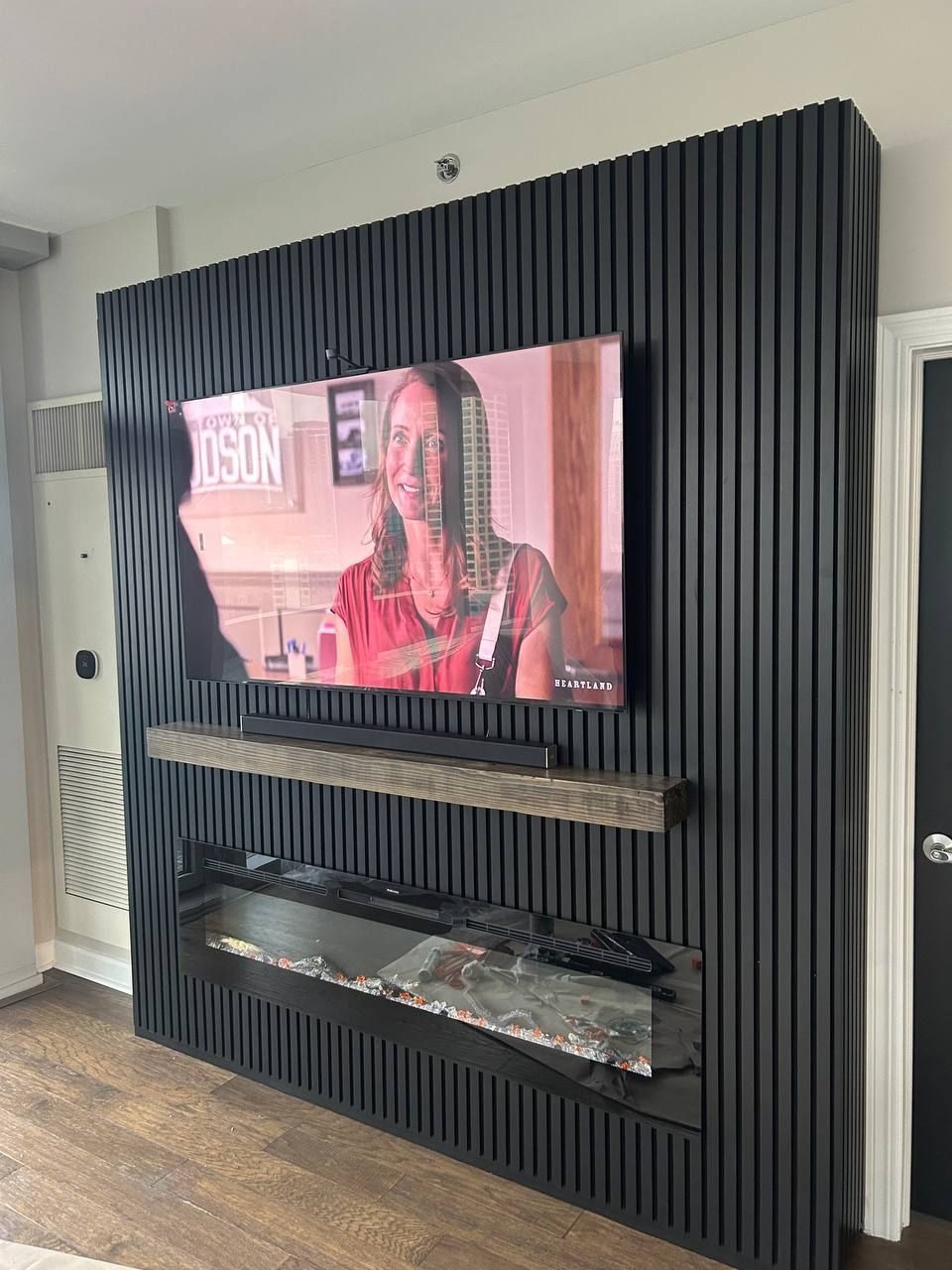 Black slat wall with fireplace